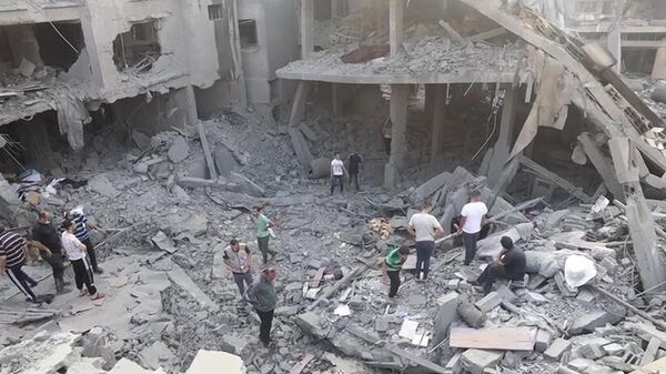 Последствия удара Израиля по жилому дому в Газе