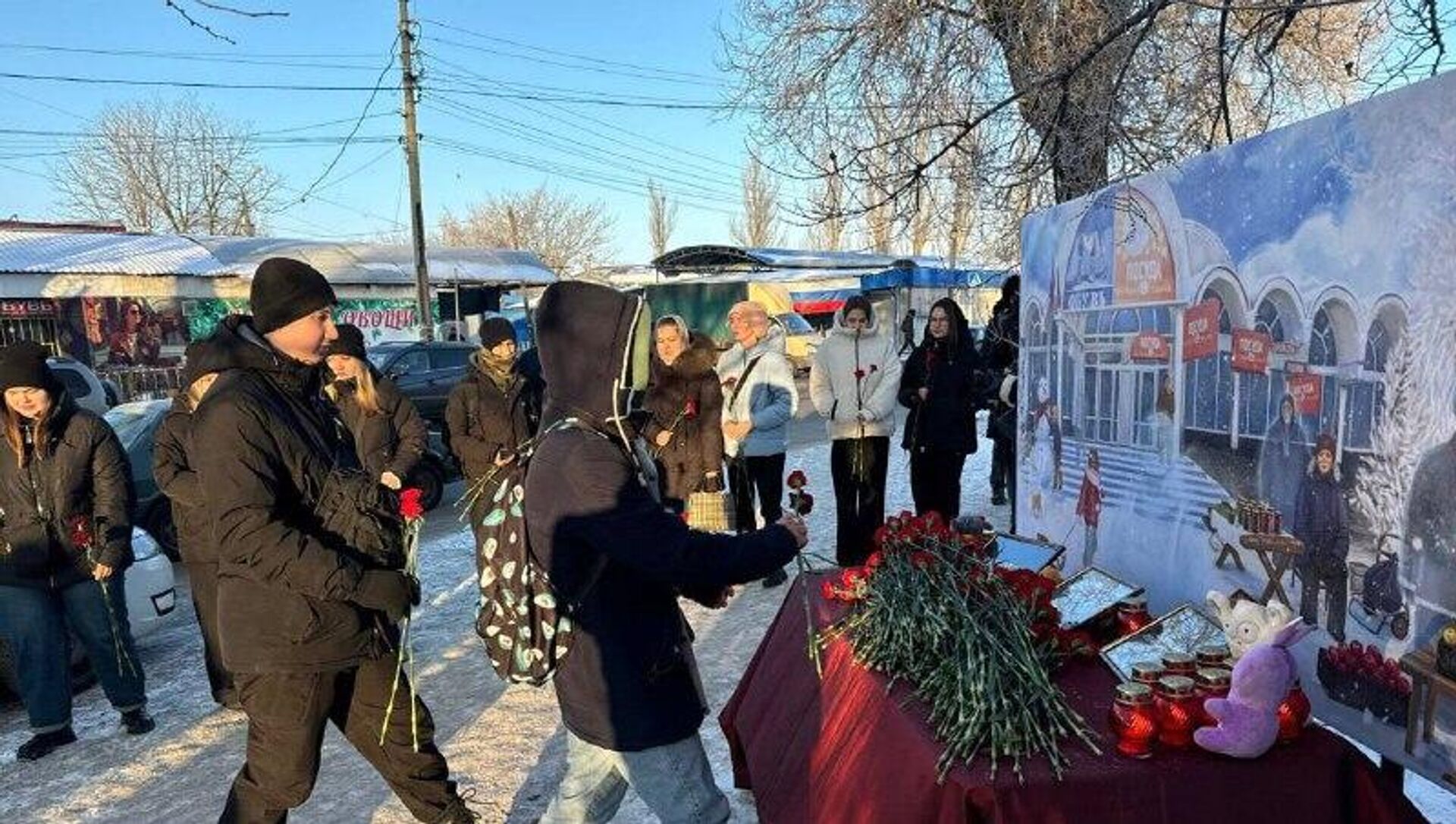 ‼ Мемориальная акция прошла на месте удара ВСУ по рынку в донецком микрорайоне Текстильщик в ДНР во вторую годовщину трагедии - РИА Новости, 1920, 21.01.2026