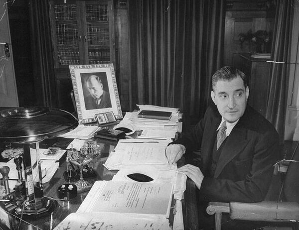 Антониу де Оливейра Салазар сидит за своим рабочим столом с портретом Муссолини с автографом (фото Бернард Хоффман, 1940)