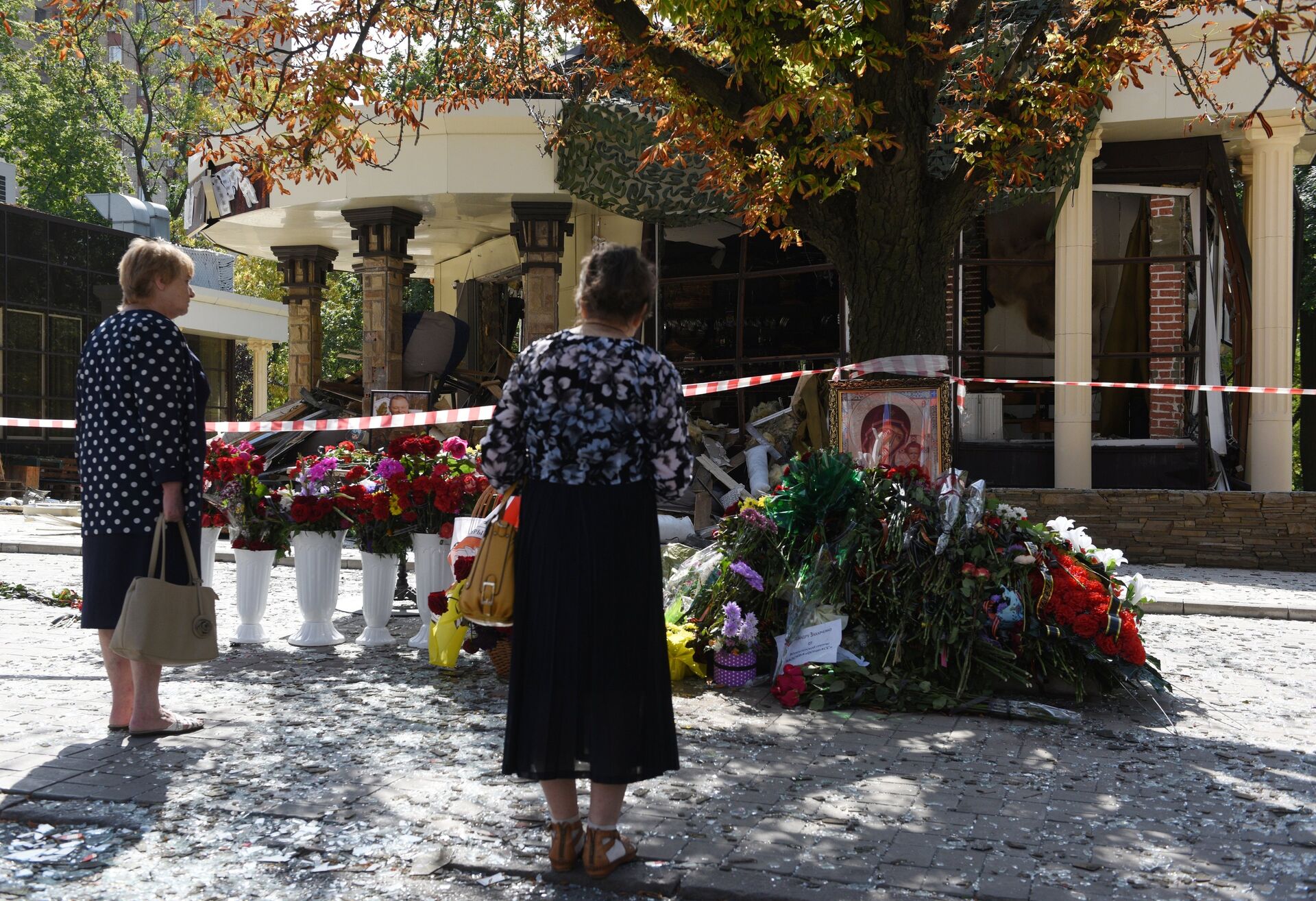 Женщины возлагают цветы к зданию кафе Сепар в Донецке, где произошел взрыв в результате которого погиб глава ДНР Александр Захарченко - РИА Новости, 1920, 31.08.2020