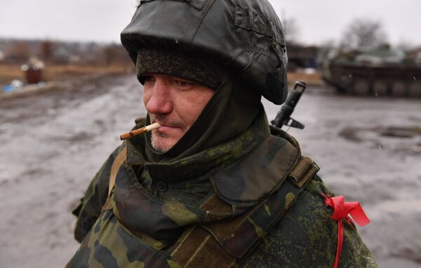 Военнослужащий войск Донецкой Народной Республики наблюдает в населенном пункте Бугас